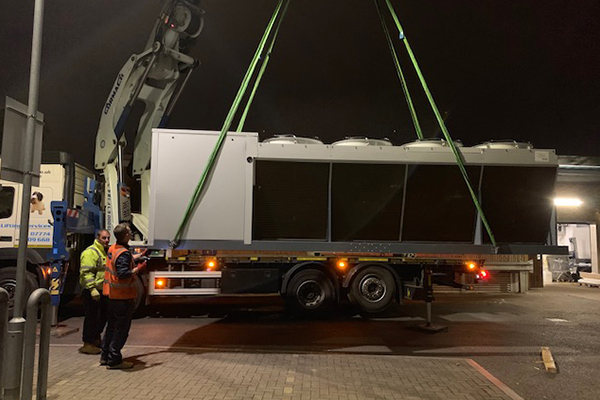 An image of us loading air conditioning units onto our lorry with the lorry-mounted HIAB crane